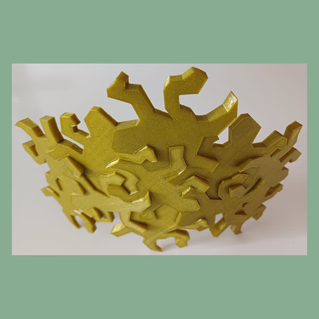 Top view of connected Escher inspired lizards snapped together showing the intended outwards curve used for decoration.